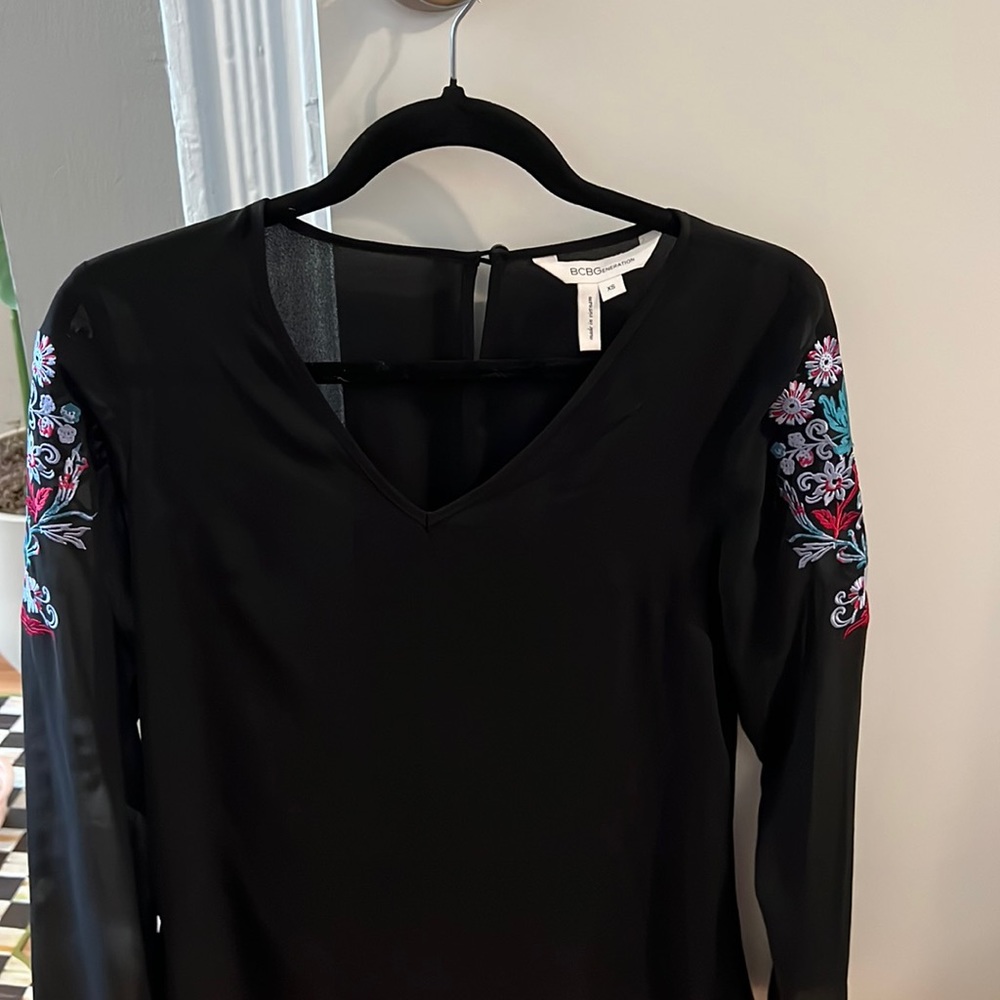 BCBGg size XS black blouse with floral sleeves